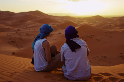 Romantic Couple Observing the Moroccan Sahara Desert Sunset